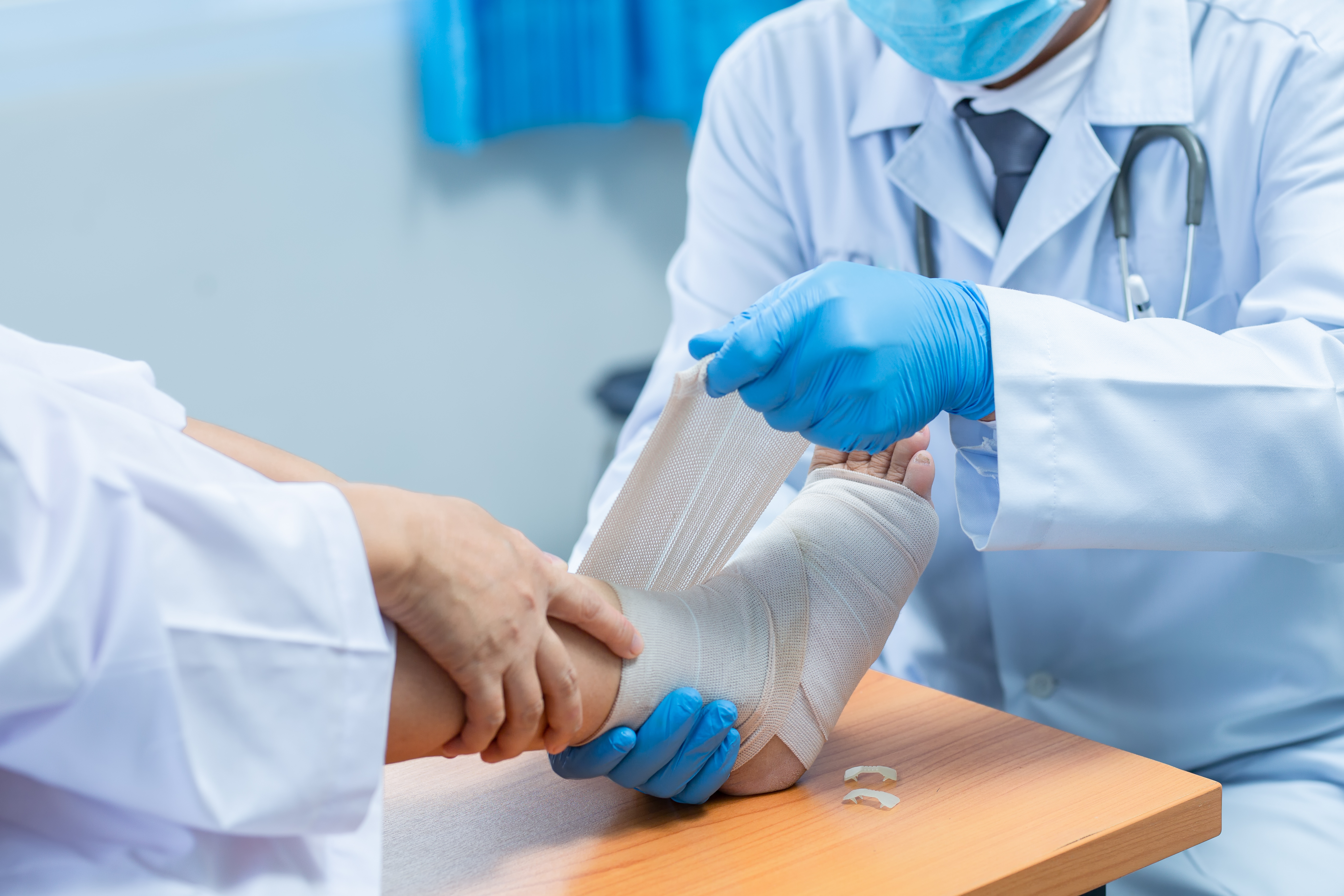 Clinician wrapping a wound care bandage